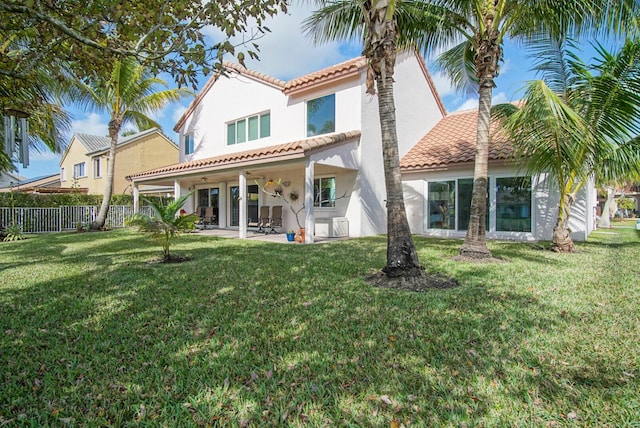 rear view of house with a yard and a patio