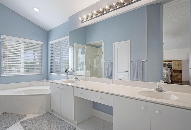 bathroom featuring plus walk in shower, vanity, tile patterned floors, and lofted ceiling