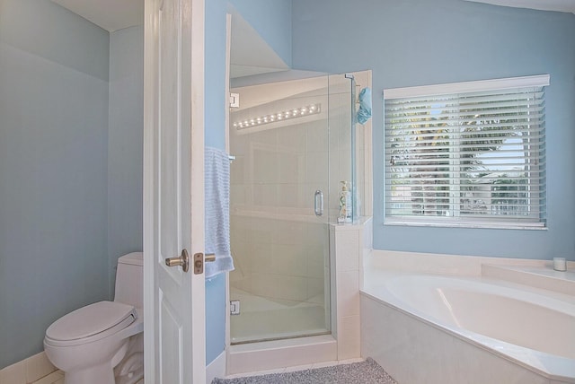 bathroom featuring toilet and independent shower and bath