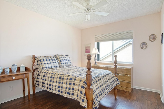 bedroom with ceiling fan, dark wood-type flooring, and a textured ceiling