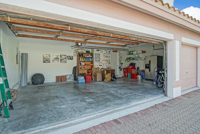 garage featuring stainless steel fridge