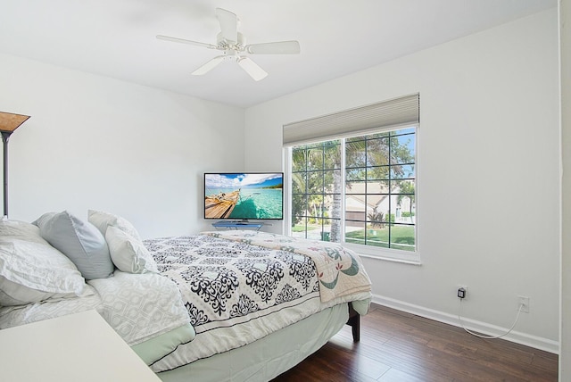 bedroom with ceiling fan and dark hardwood / wood-style floors