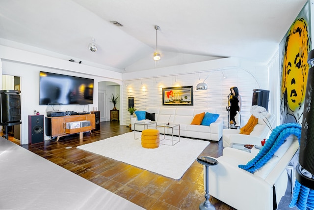 living room featuring arched walkways, wood finished floors, lofted ceiling, and visible vents