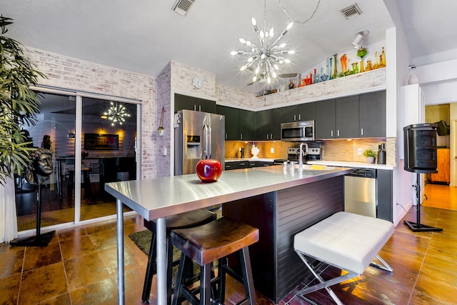 kitchen featuring visible vents, appliances with stainless steel finishes, light countertops, and dark cabinets