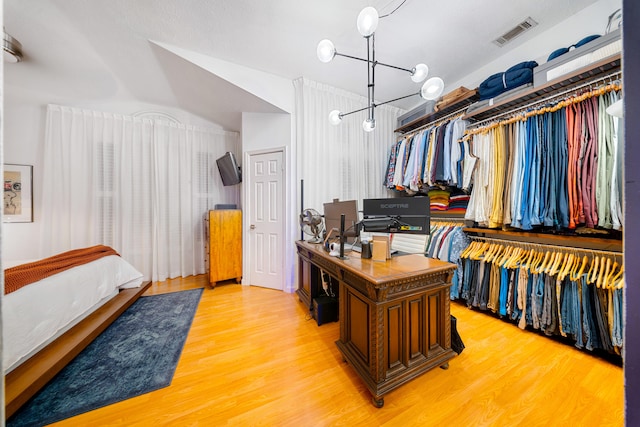 walk in closet featuring light wood finished floors and visible vents