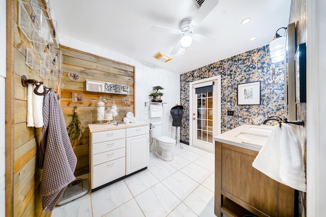 bathroom with marble finish floor, recessed lighting, toilet, ceiling fan, and vanity