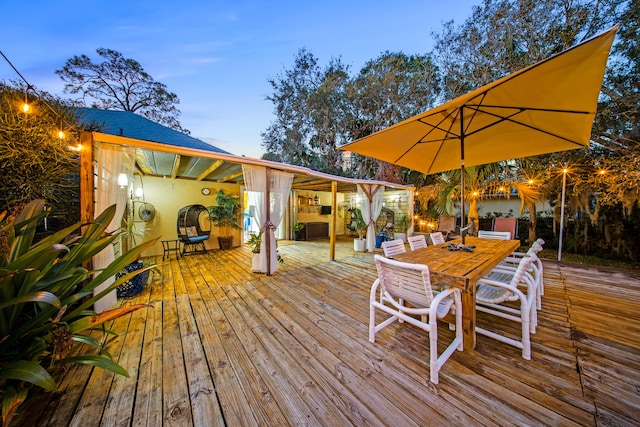 wooden terrace with outdoor dining space