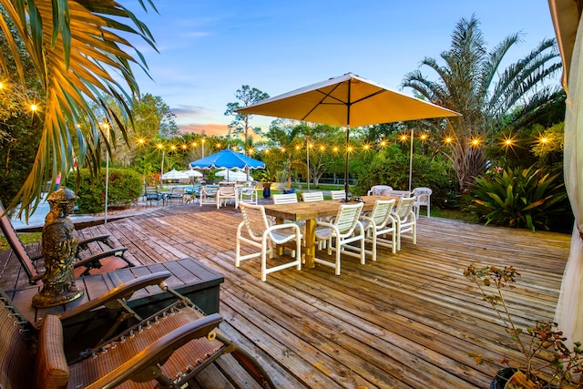 deck at dusk with outdoor dining area