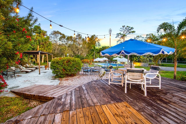 deck at dusk with outdoor dining space