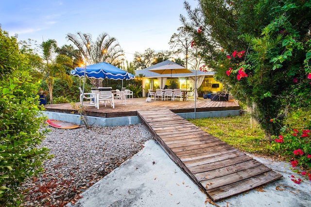 view of yard featuring outdoor dining area and a wooden deck