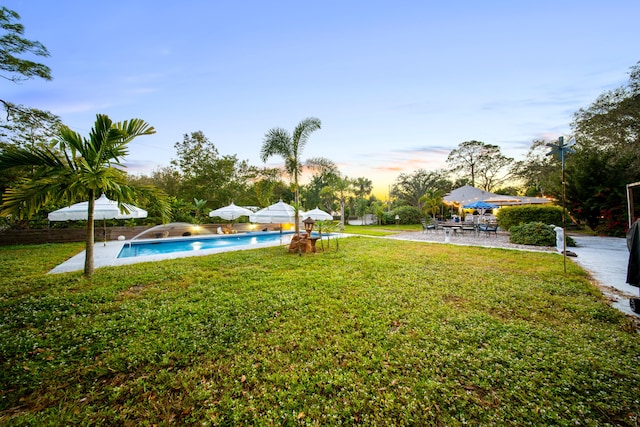 view of yard with an outdoor pool and a patio