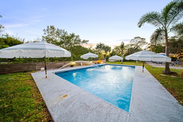 pool featuring a yard and a patio