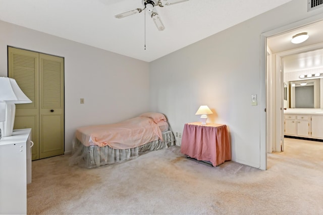 carpeted bedroom featuring ceiling fan and a closet