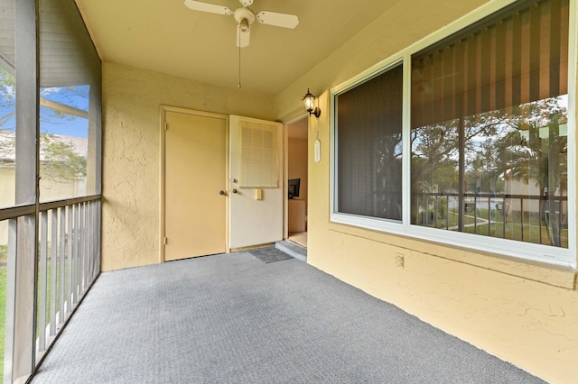 exterior space featuring ceiling fan and a balcony