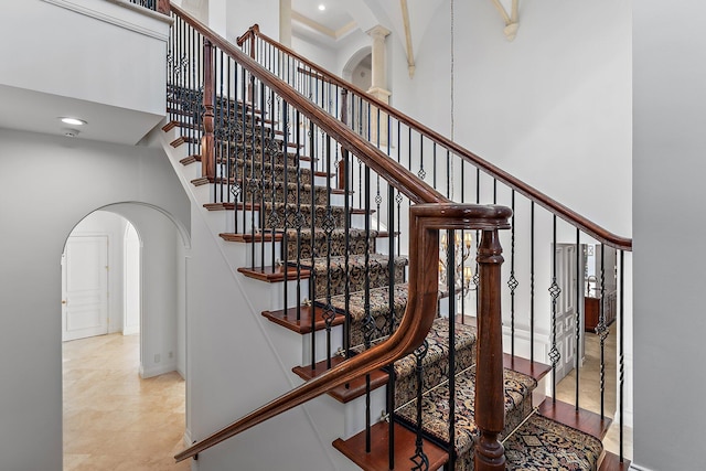 staircase with a towering ceiling