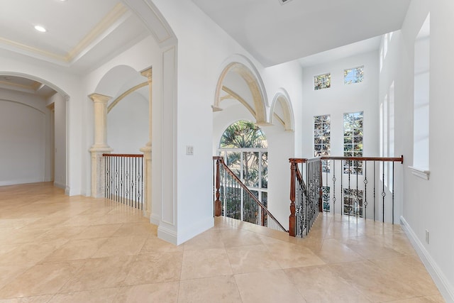 hall featuring light tile patterned flooring and ornamental molding