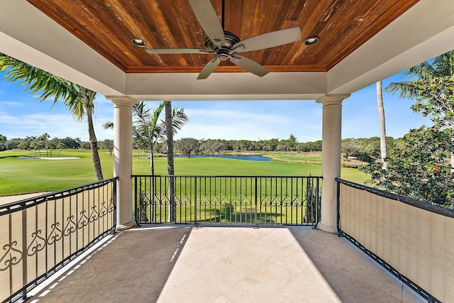 view of patio with a water view and ceiling fan