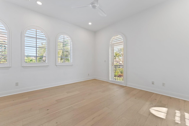 spare room with ceiling fan and light wood-type flooring