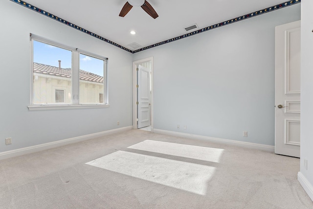 carpeted empty room featuring ceiling fan