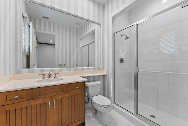 bathroom featuring vanity, toilet, and walk in shower