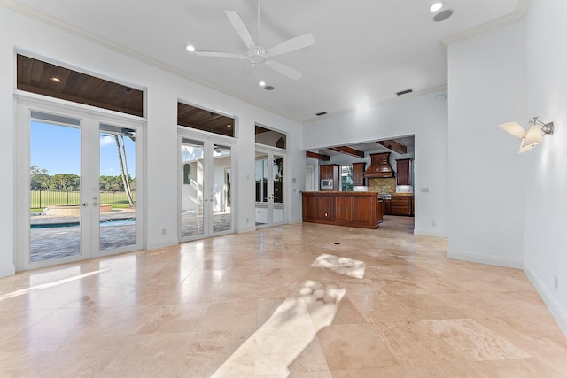 unfurnished living room featuring ceiling fan, ornamental molding, and french doors