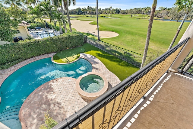 view of pool with a yard and an in ground hot tub