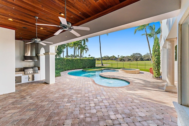 view of pool featuring ceiling fan, an in ground hot tub, area for grilling, exterior kitchen, and a patio