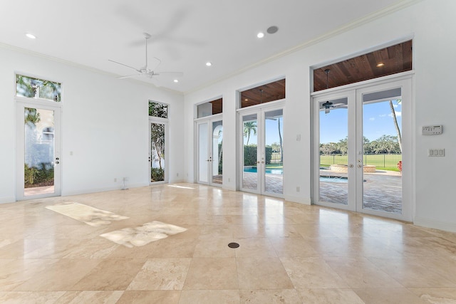 empty room with french doors, ceiling fan, and crown molding