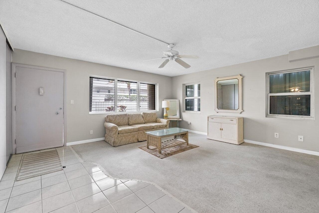 carpeted living room featuring a textured ceiling and ceiling fan