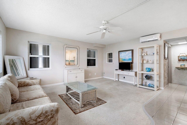 living room featuring ceiling fan, an AC wall unit, and a textured ceiling