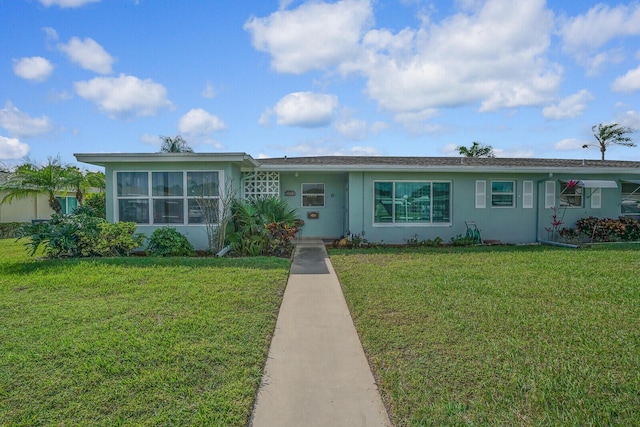 ranch-style home with a front lawn and stucco siding