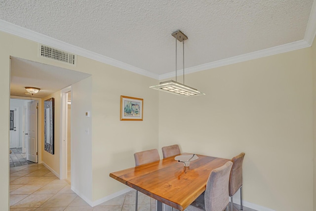 dining space featuring a textured ceiling, light tile patterned flooring, visible vents, and crown molding