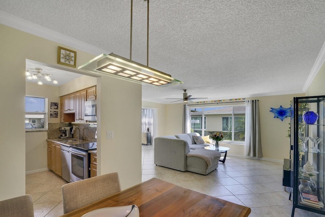 dining room featuring light tile patterned floors, baseboards, a ceiling fan, ornamental molding, and a textured ceiling