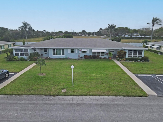 ranch-style home with a front lawn