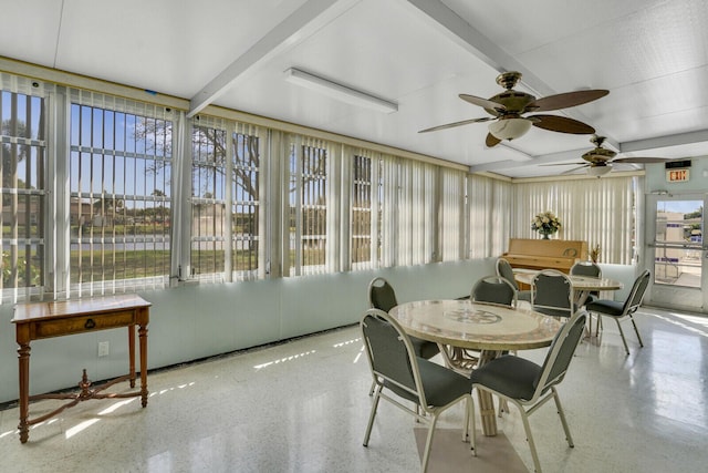 sunroom featuring plenty of natural light and beam ceiling