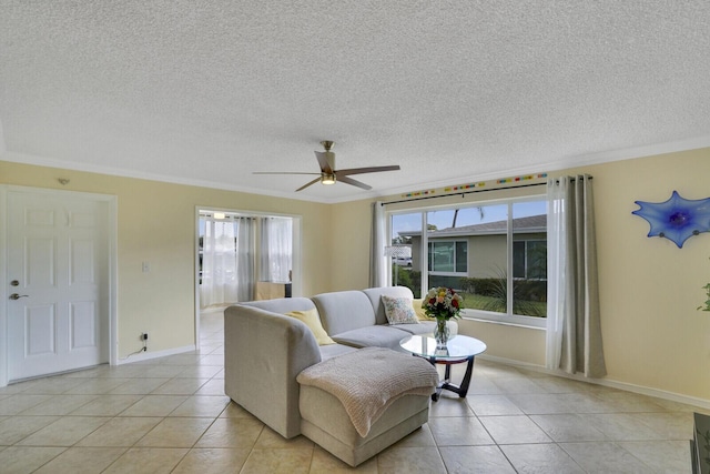 living room with ornamental molding, light tile patterned flooring, a textured ceiling, and a ceiling fan