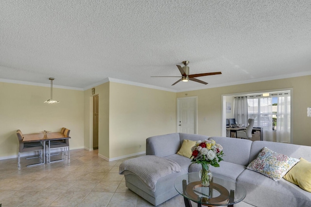 living area featuring crown molding, light tile patterned flooring, ceiling fan, a textured ceiling, and baseboards