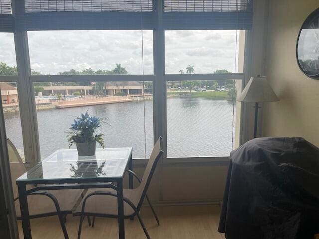 sunroom featuring a water view