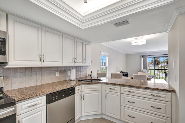 kitchen featuring white cabinetry, sink, kitchen peninsula, appliances with stainless steel finishes, and ornamental molding