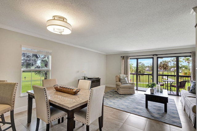 dining space with tile patterned floors, plenty of natural light, and crown molding