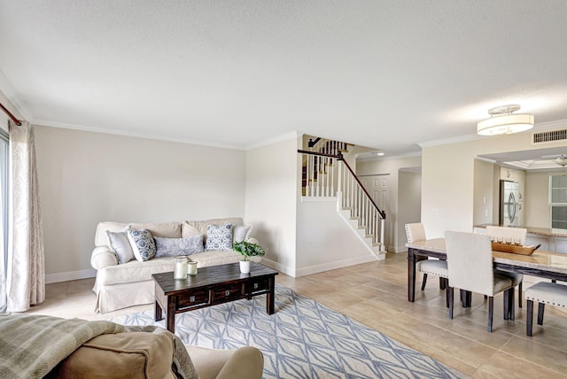 living room featuring light tile patterned flooring, ornamental molding, and a textured ceiling