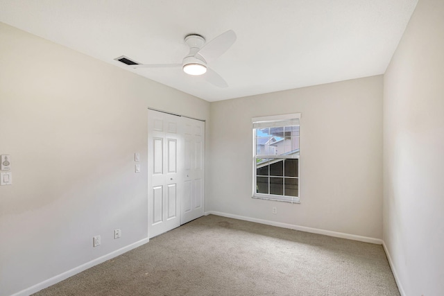 carpeted empty room with ceiling fan