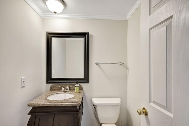 bathroom featuring vanity, toilet, and crown molding