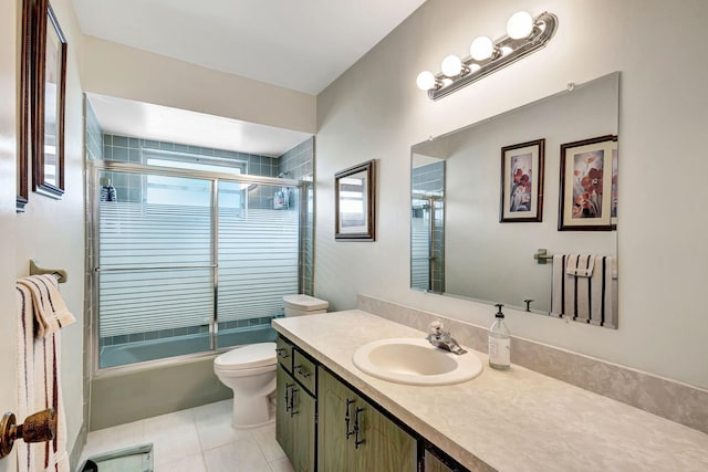 full bathroom with shower / bath combination with glass door, vanity, toilet, and tile patterned flooring