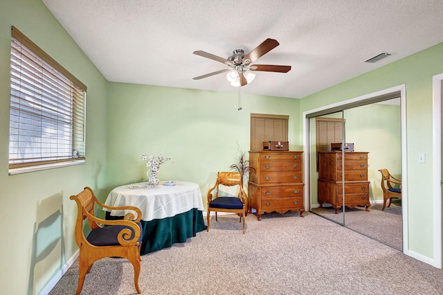 bedroom featuring carpet, ceiling fan, and a closet