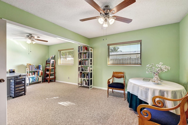 sitting room featuring carpet flooring, ceiling fan, a textured ceiling, and a wealth of natural light