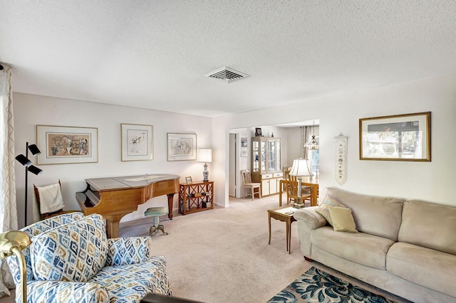 carpeted living room with a textured ceiling