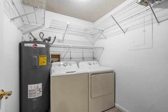 laundry room with washer and dryer, electric water heater, and a textured ceiling