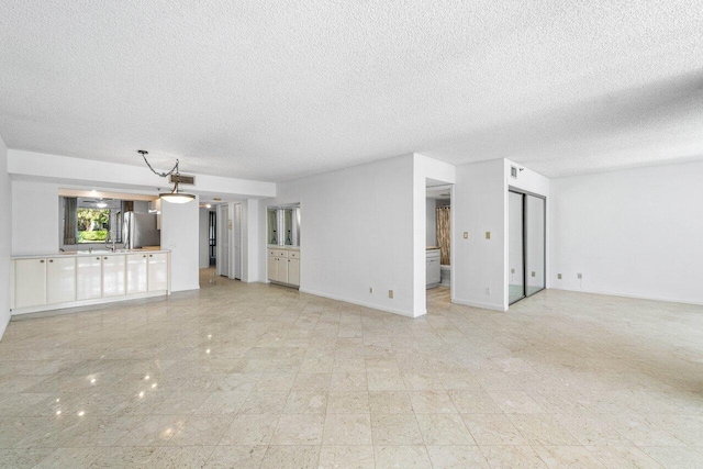 unfurnished living room featuring a textured ceiling