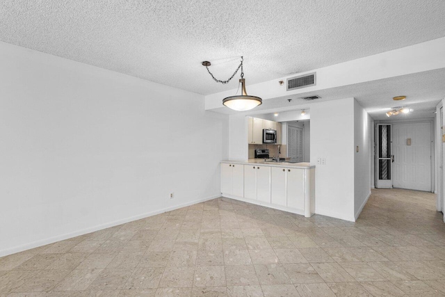 unfurnished living room featuring a textured ceiling